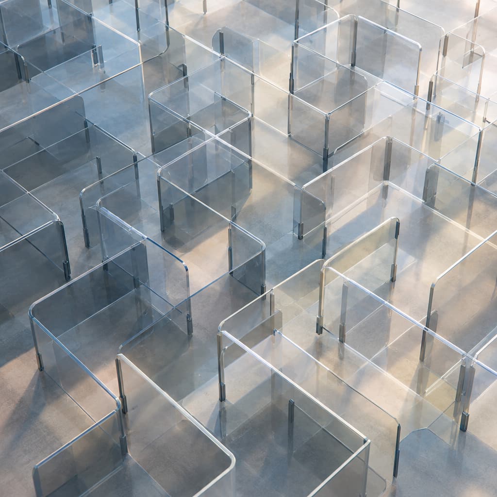 A labyrinth of transparent hurdles representing complex administrative processes obscuring a clear path.